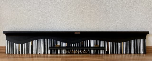 this is an old piano cover from a Manegold piano painted in commission for a client. Unique and vibrant artwork in black, white and golden by german woman artist Astrid Stoeppel
